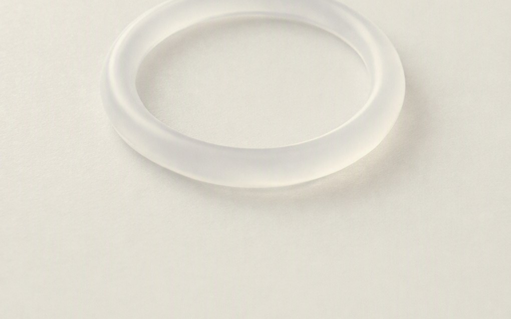 Frosted translucent ring on a pale surface