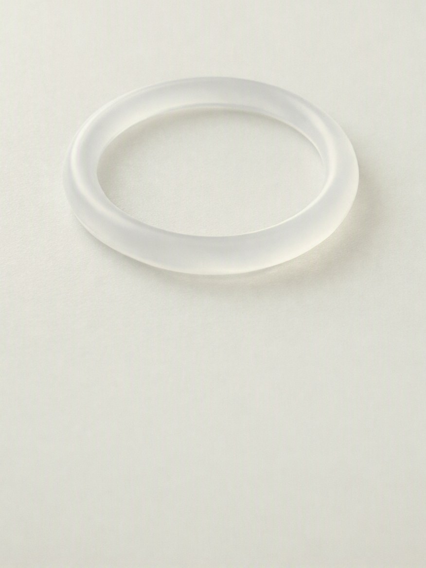 Frosted translucent ring on a pale surface